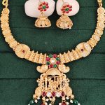 South Indian Jewelry Necklace Set with Lakshmi Pendant, Ruby & Green Stones, Coin Design, and Matching Jhumka Earrings for Occasional Wear